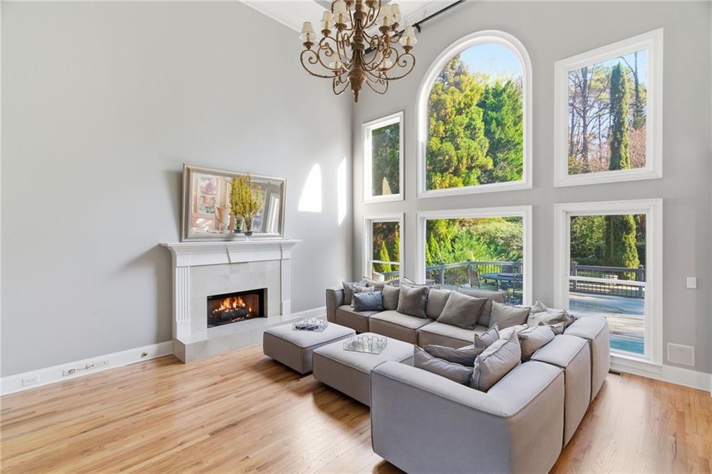 1607 Oak Grove Road Decatur, GA 30033 - Photo 9 of 71 a living room with furniture a chandelier and a fireplace