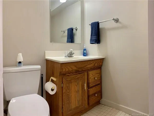 a bathroom with a toilet sink and mirror