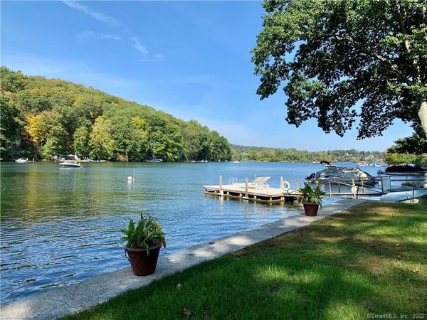 an aerial view of a house with outdoor space and lake view
