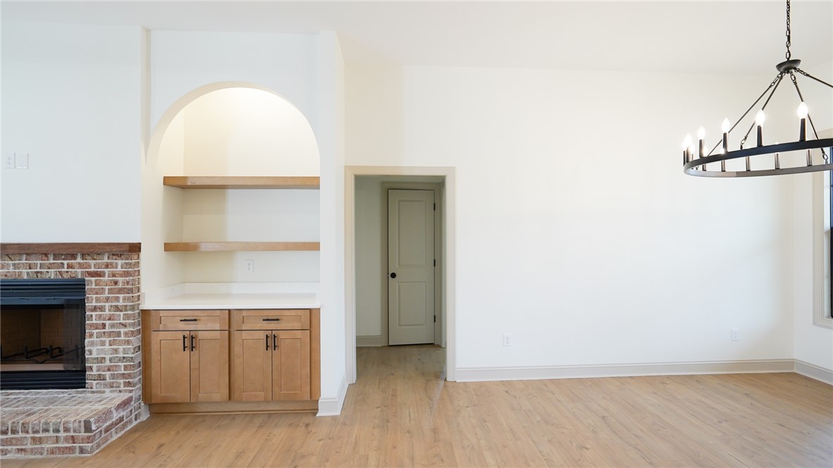1001 Five Forks Road Pendleton, SC 29670 - Photo 15 of 43 This bright room features a beautiful fireplace, built-in shelving, and warm wood flooring.