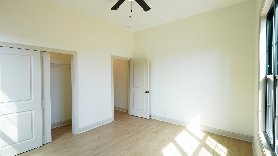 1001 Five Forks Road Pendleton, SC 29670 - Photo 20 of 43 This airy bedroom features abundant natural light and warm flooring, creating a comfortable living space.