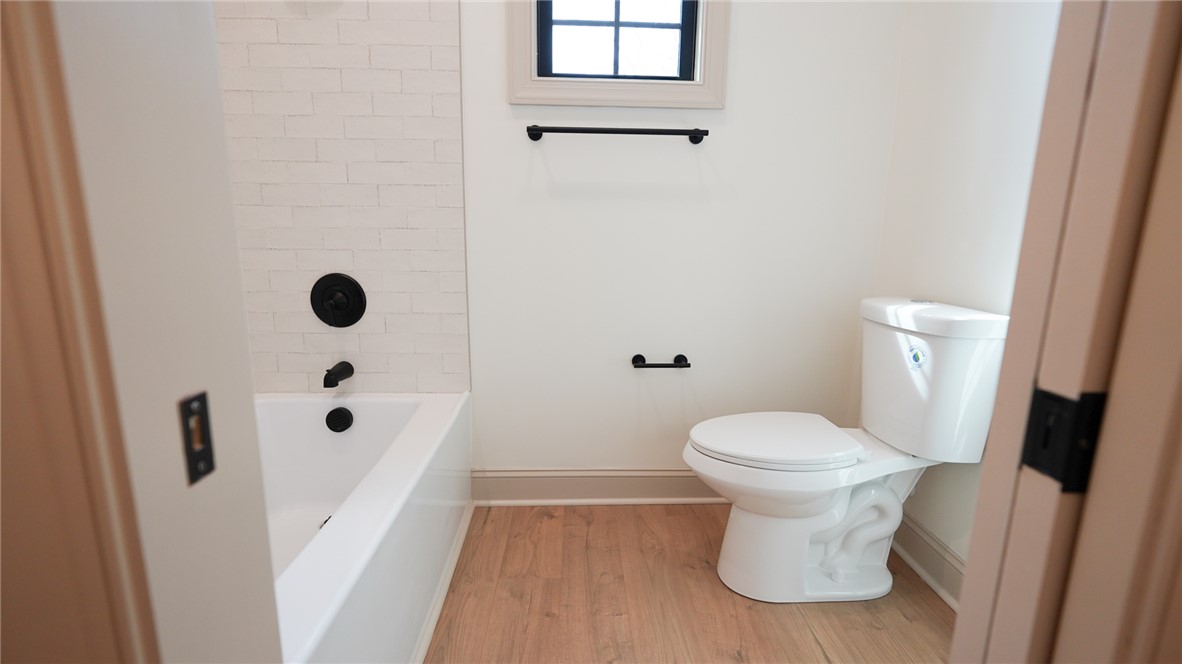 1001 Five Forks Road Pendleton, SC 29670 - Photo 22 of 43 This bright bathroom features durable flooring and a classic tub with modern fixtures.