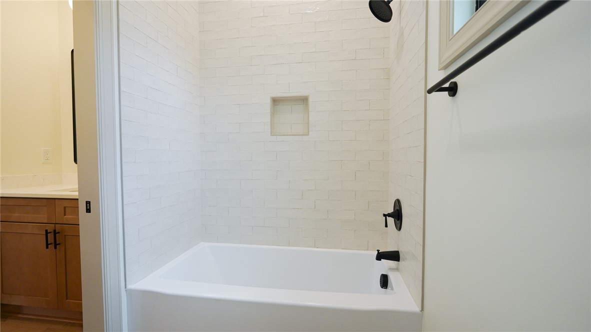 1001 Five Forks Road Pendleton, SC 29670 - Photo 23 of 43 This clean and bright bathroom features a modern tub and shower combination with stylish black fixtures.