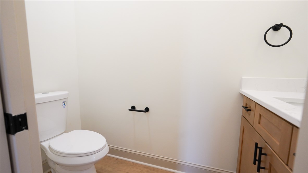 1001 Five Forks Road Pendleton, SC 29670 - Photo 24 of 43 This powder room features bright walls and a warm wood vanity with modern fixtures.