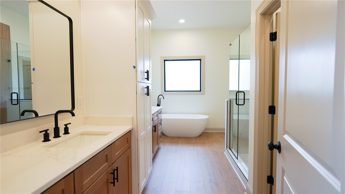 1001 Five Forks Road Pendleton, SC 29670 - Photo 29 of 43 This sleek bathroom features a standalone tub and a glass-enclosed shower, complemented by dual vanities.