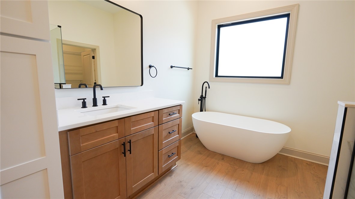 1001 Five Forks Road Pendleton, SC 29670 - Photo 30 of 43 This bright bathroom features a sleek vanity and a freestanding tub, offering a relaxing escape.