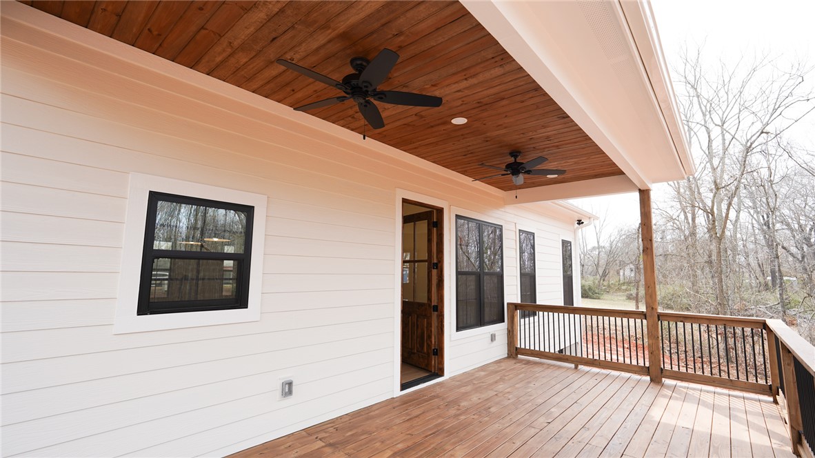 1001 Five Forks Road Pendleton, SC 29670 - Photo 38 of 43 This spacious covered deck offers a seamless connection to nature, perfect for outdoor living and entertaining.