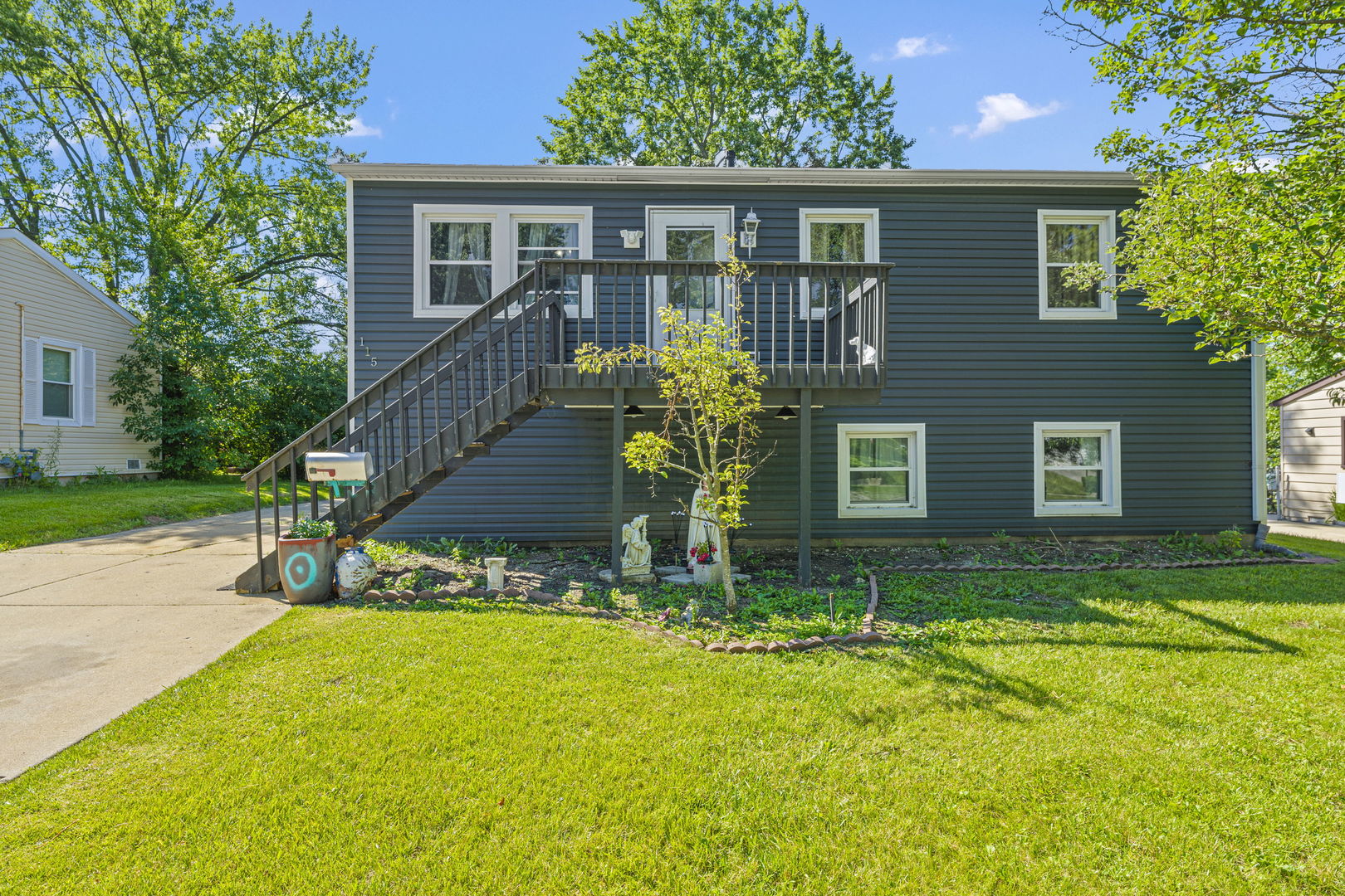 115 Elm Lane Streamwood, IL 60107 - Photo 1 of 1 a front view of a house with garden