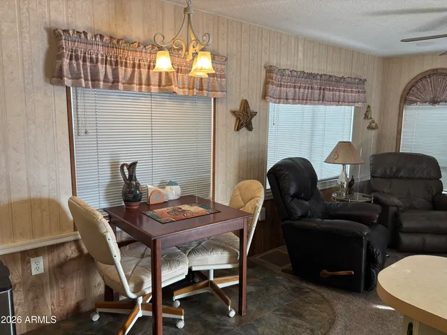 a dining room with furniture and wooden floor