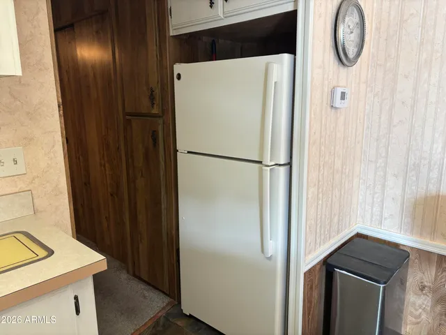 a white refrigerator freezer sitting inside of a kitchen