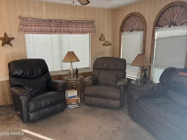 a living room with furniture and a lamp