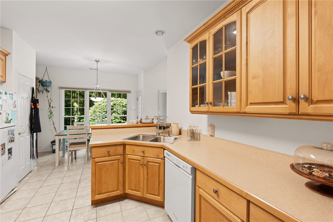 108 Winterbrook Circle Seneca, SC 29678 - Photo 19 of 40 A well-lit kitchen with natural wood cabinetry and a view of verdant foliage.