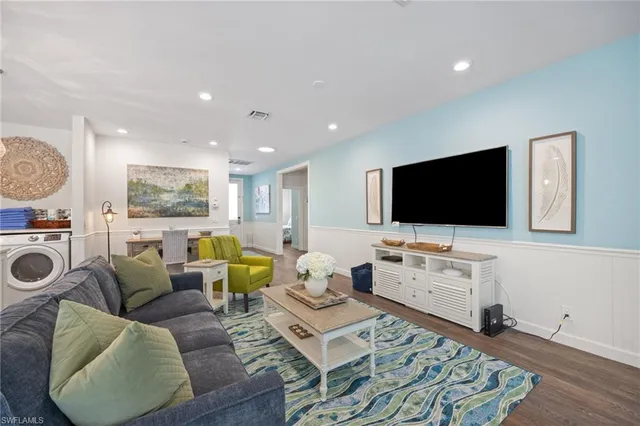 a living room with furniture kitchen and a table