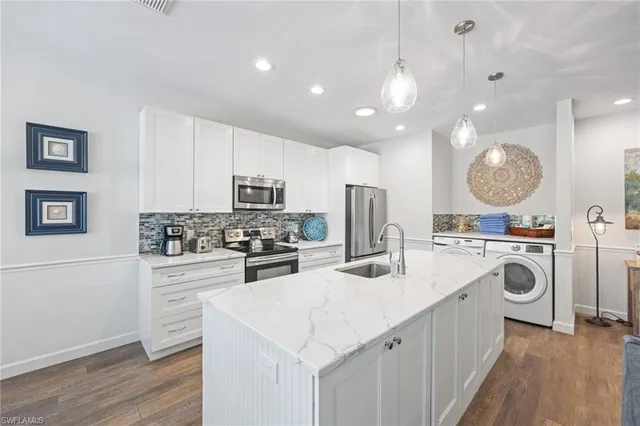 a kitchen with a sink stove and cabinets