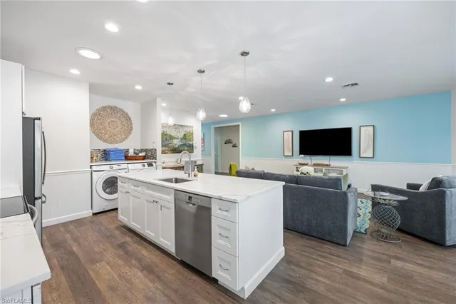 a view of living room kitchen island dining table and chairs