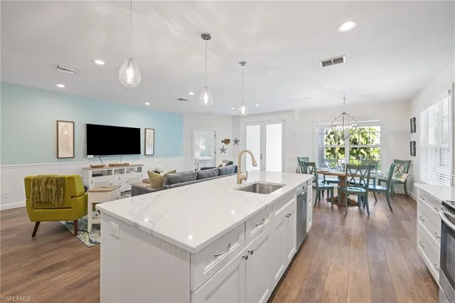 a view of a kitchen with stainless steel appliances granite countertop a refrigerator and a sink