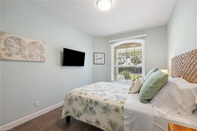 a bedroom with a bed and a lamp