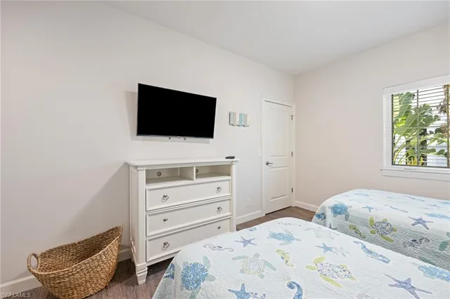 a room with gym equipment and wooden floor