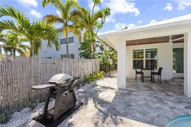 a view of a house with backyard and sitting area