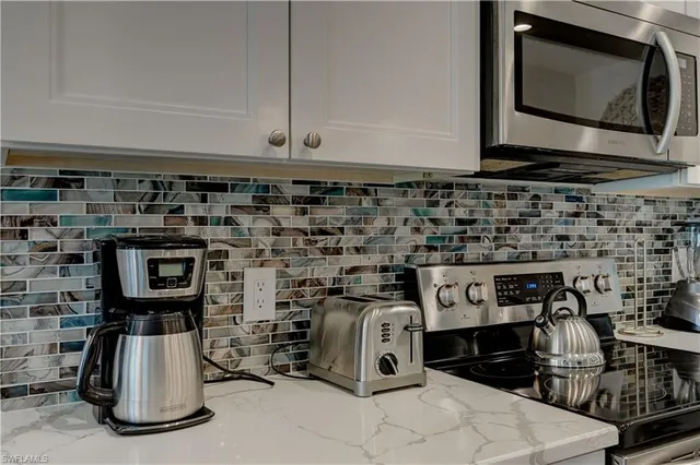 a close view of a stove a microwave and cabinets