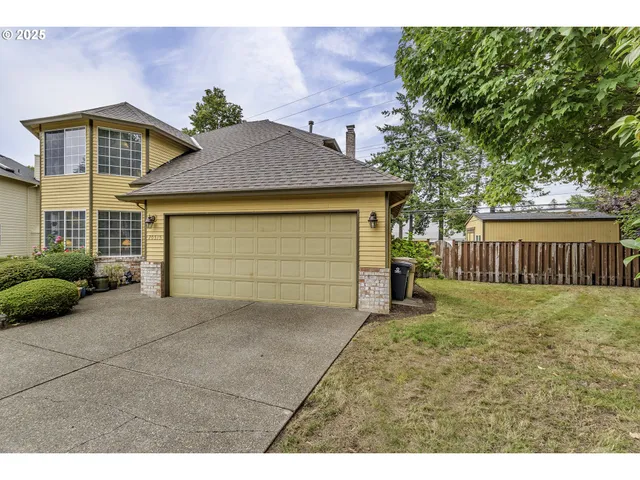 a view of a house with a yard and garage