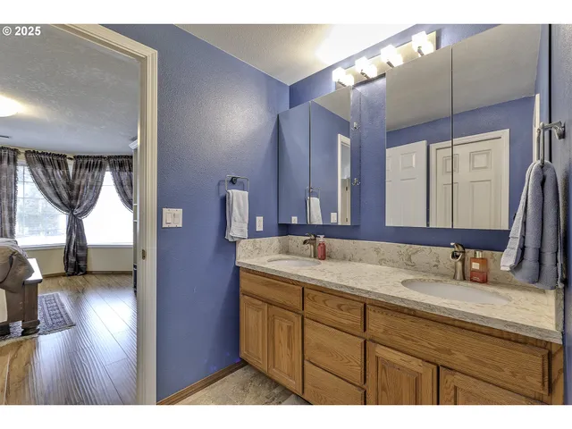 a bathroom with a sink vanity granite and a mirror