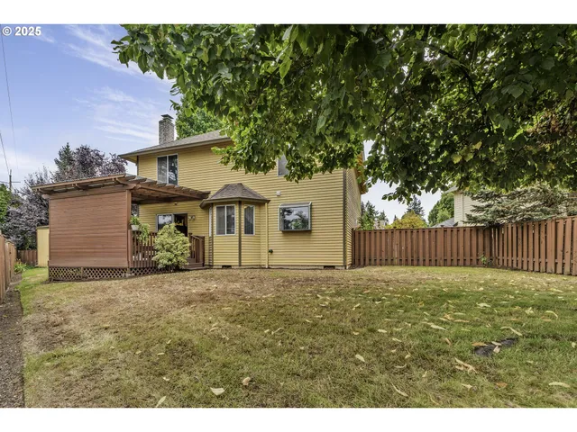 a view of backyard of house with green space