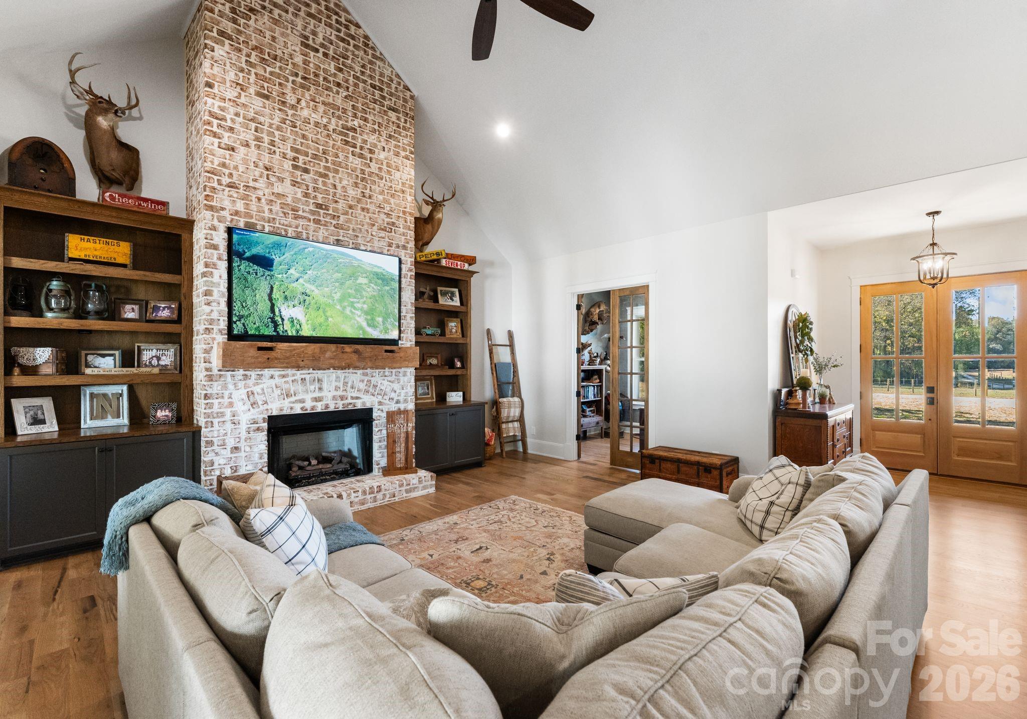 3760 Cappadocia Church Road Polkton, NC 28135 - Photo 14 of 48 a living room with furniture a fireplace and a flat screen tv