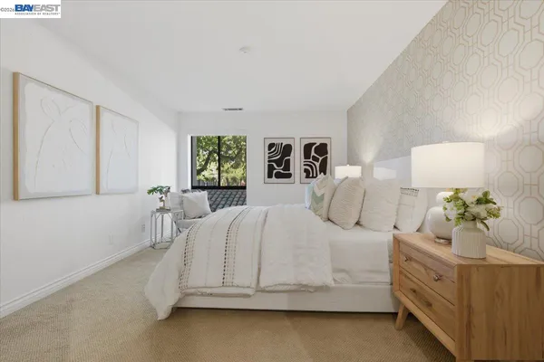 an aerial view of a city with lots of residential buildings and ocean view in back