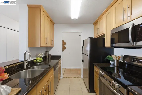 a living room with furniture chandelier and a large window