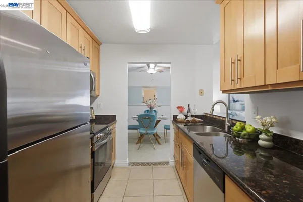 a living room with furniture a chandelier and a window