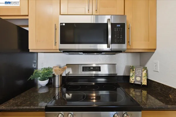 a bathroom with a granite countertop sink a toilet and bathtub