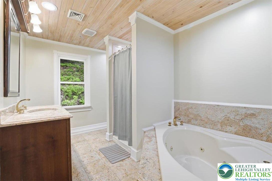 3585 Fairyland Road Lehighton, PA 18235 - Photo 47 of 57 a bathroom with a tub sink and window