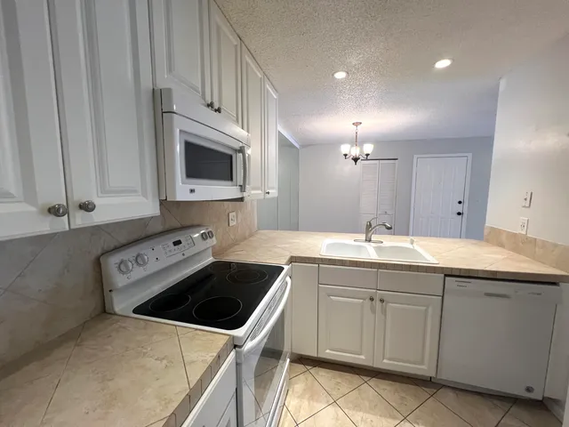 a kitchen with a sink and a stove top oven