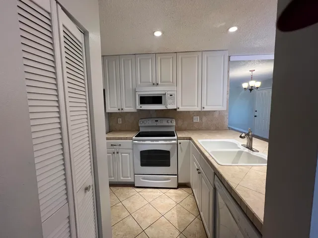 a kitchen with a sink stove and cabinets