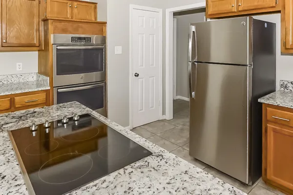 a kitchen with a refrigerator and a stove