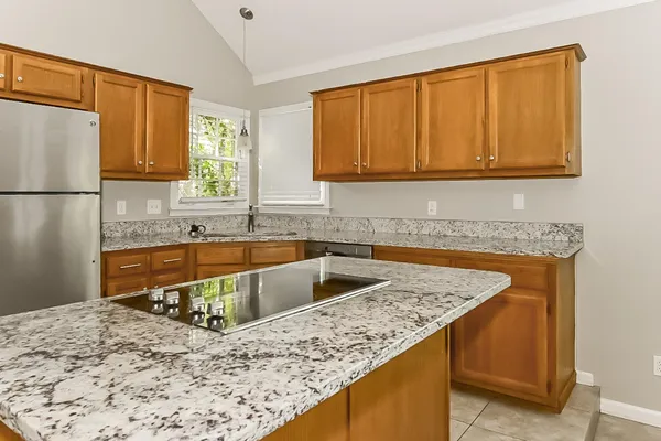 a kitchen with a stove a sink and a refrigerator