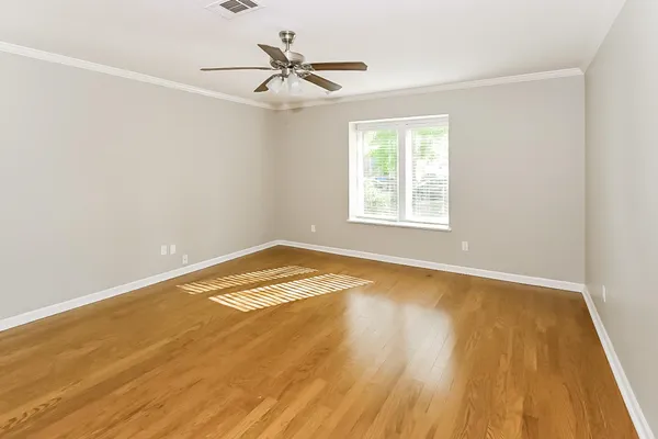 a view of a room with wooden floor and window