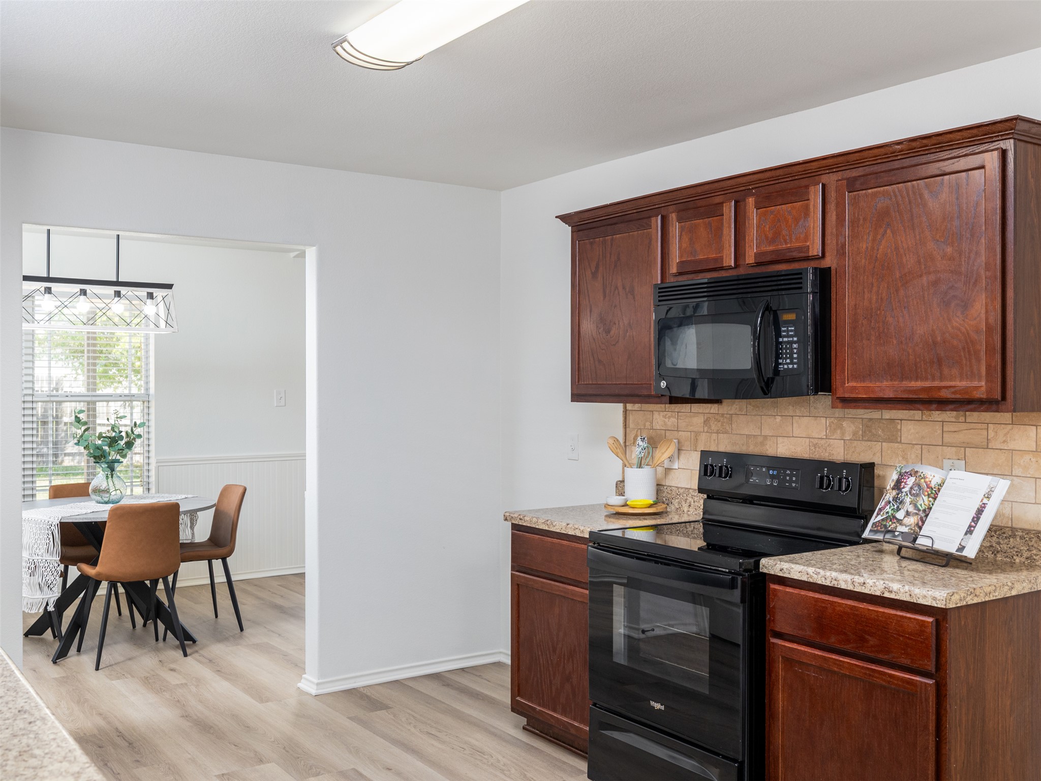 133 Lignite Drive Jarrell, TX 76537 - Photo 11 of 36 The kitchen flows naturally into the dining and living areas, making it easy to stay connected with family and guests while cooking.