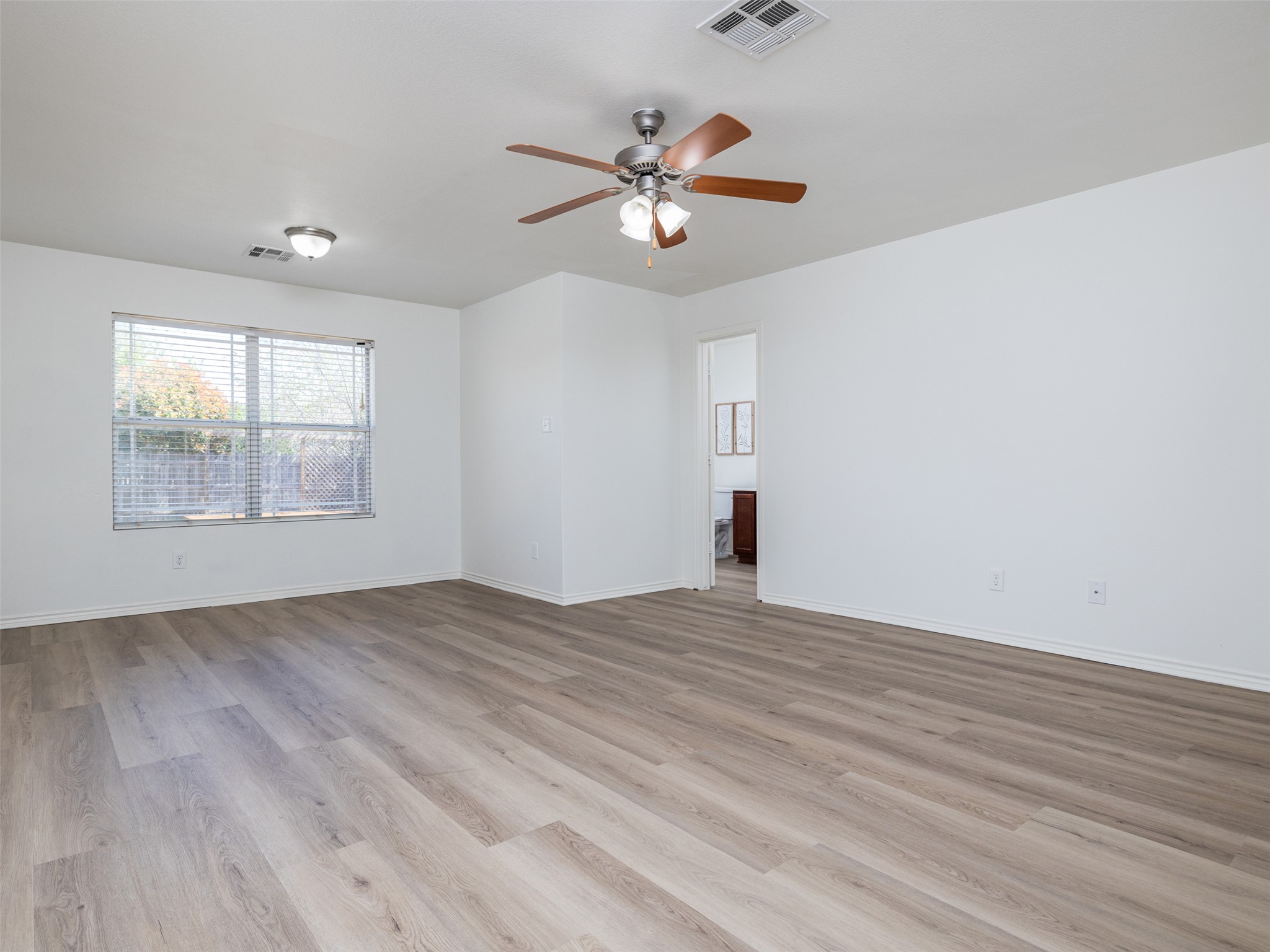 133 Lignite Drive Jarrell, TX 76537 - Photo 12 of 36 The primary bedroom is a generous retreat with updated flooring, fresh paint, and natural light that creates a calm and restful environment at the end of the day.