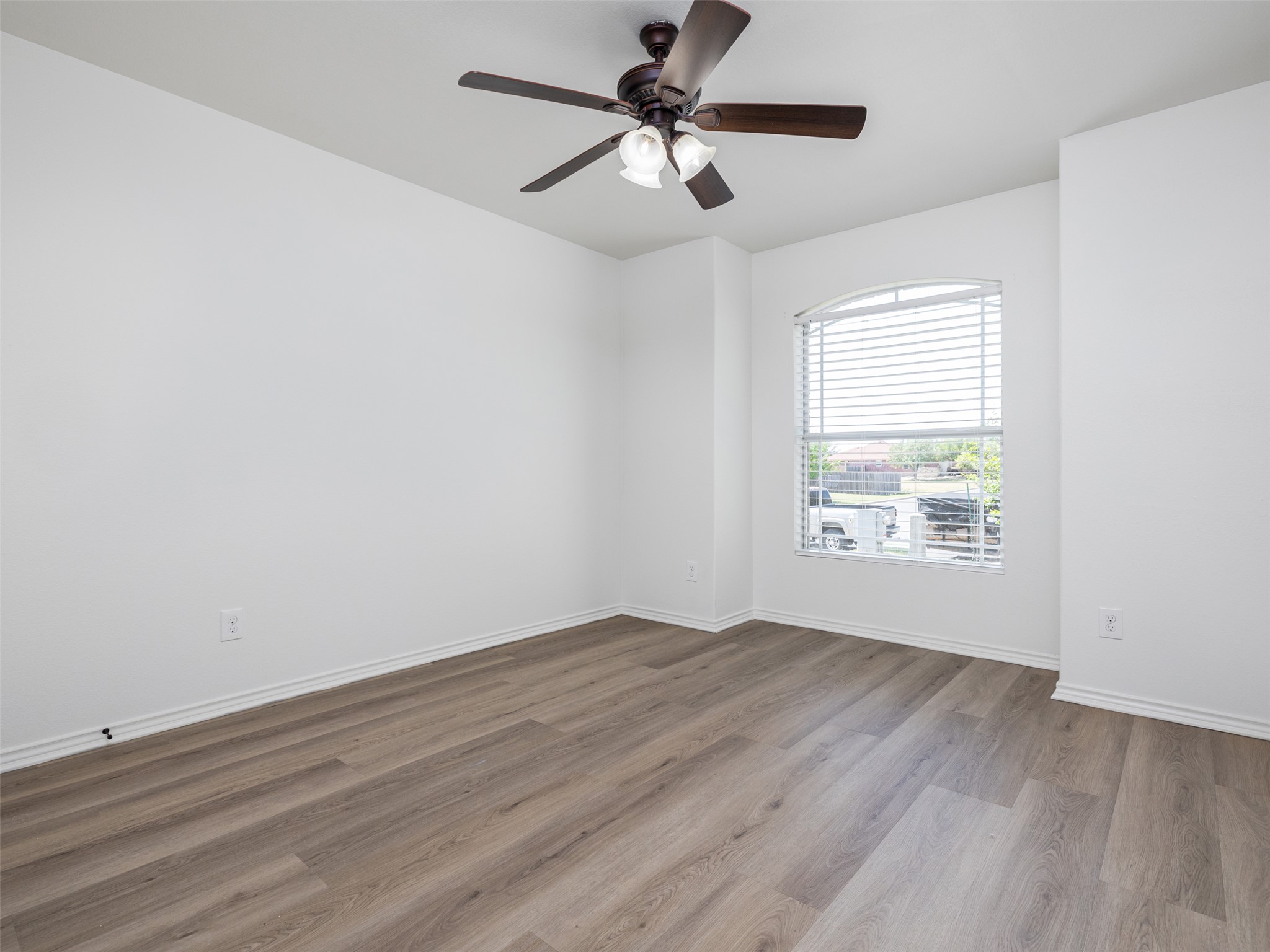 133 Lignite Drive Jarrell, TX 76537 - Photo 15 of 36 A well-sized secondary bedroom with updated flooring and fresh paint — versatile enough to serve as a kids room, guest room, or dedicated home office.