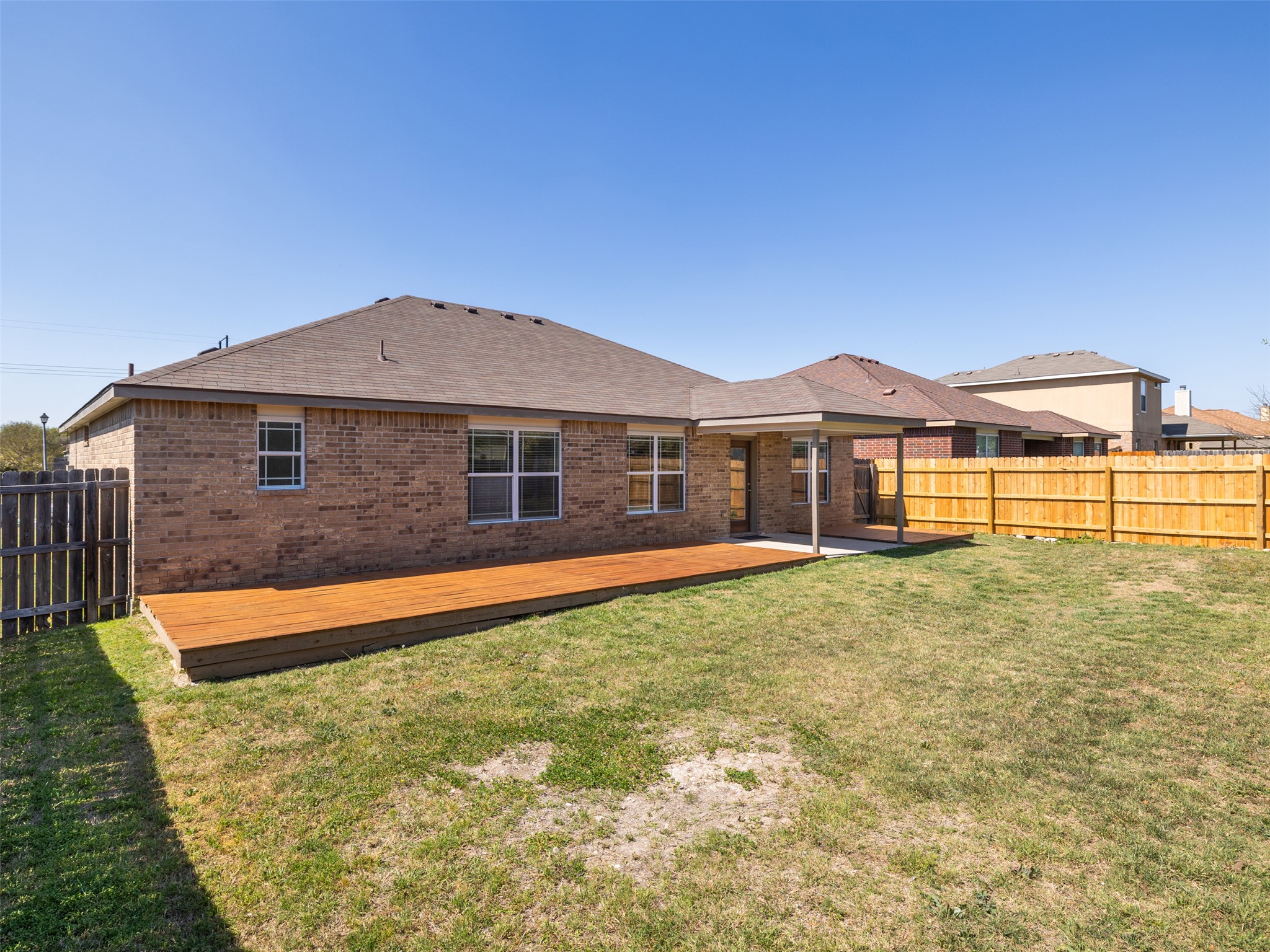 133 Lignite Drive Jarrell, TX 76537 - Photo 20 of 36 Looking back at the home from the yard, you can truly appreciate the thoughtful outdoor layout and the seamless connection between indoor and outdoor living.
