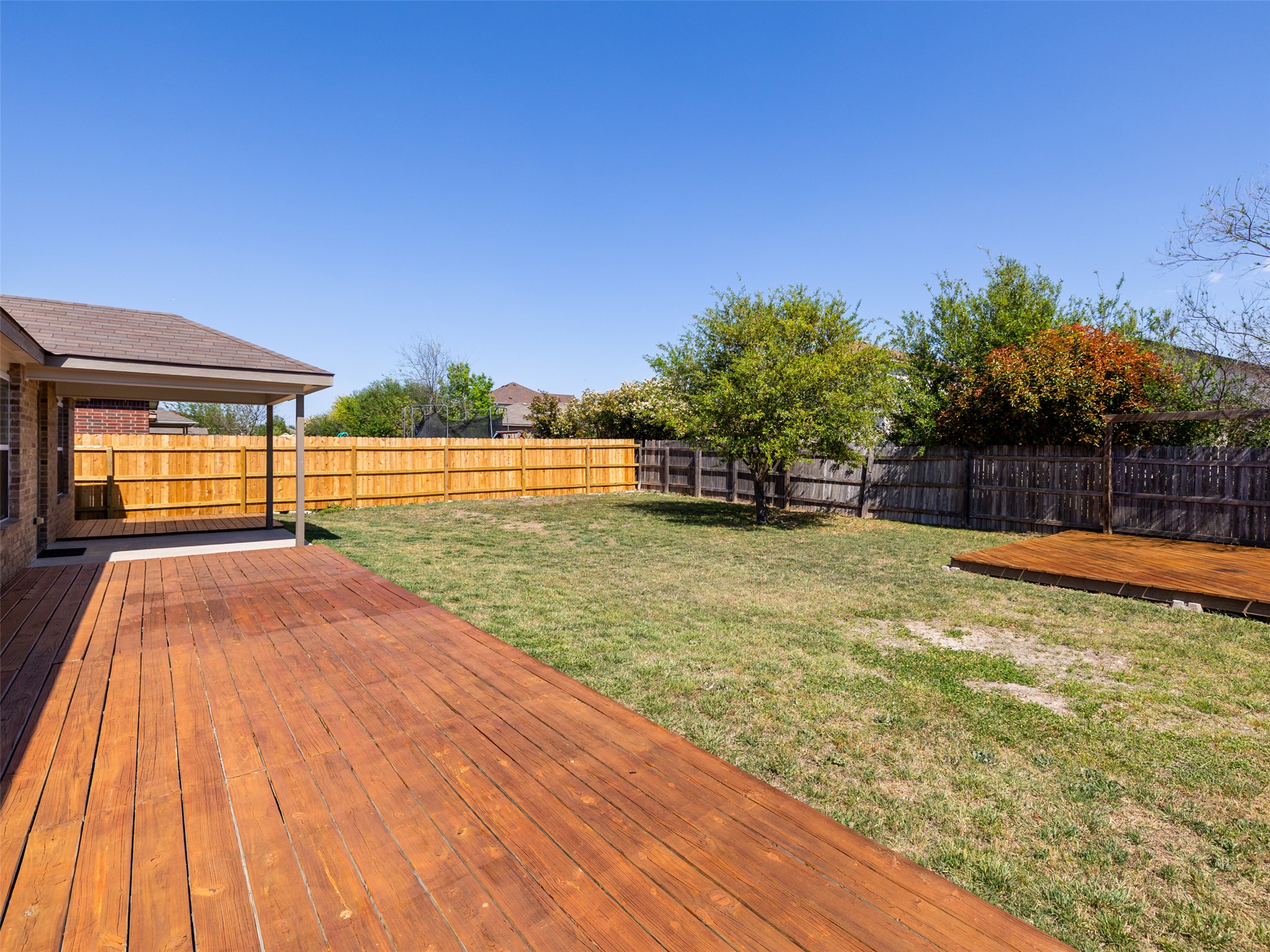 133 Lignite Drive Jarrell, TX 76537 - Photo 21 of 36 The corner built patio adds a unique and functional outdoor feature that sets this backyard apart — gather around a firepit and make memories under the stars.