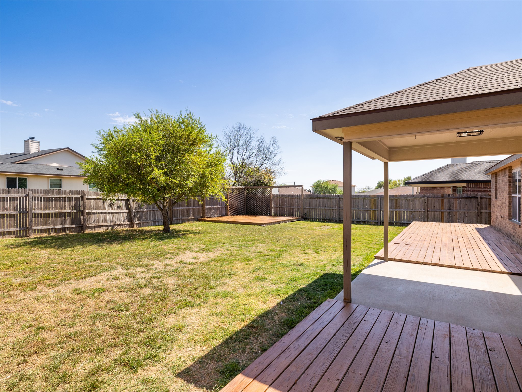 133 Lignite Drive Jarrell, TX 76537 - Photo 22 of 36 With a covered patio on one end and a dedicated corner firepit area on the other, this backyard is designed for year-round outdoor living and entertaining.