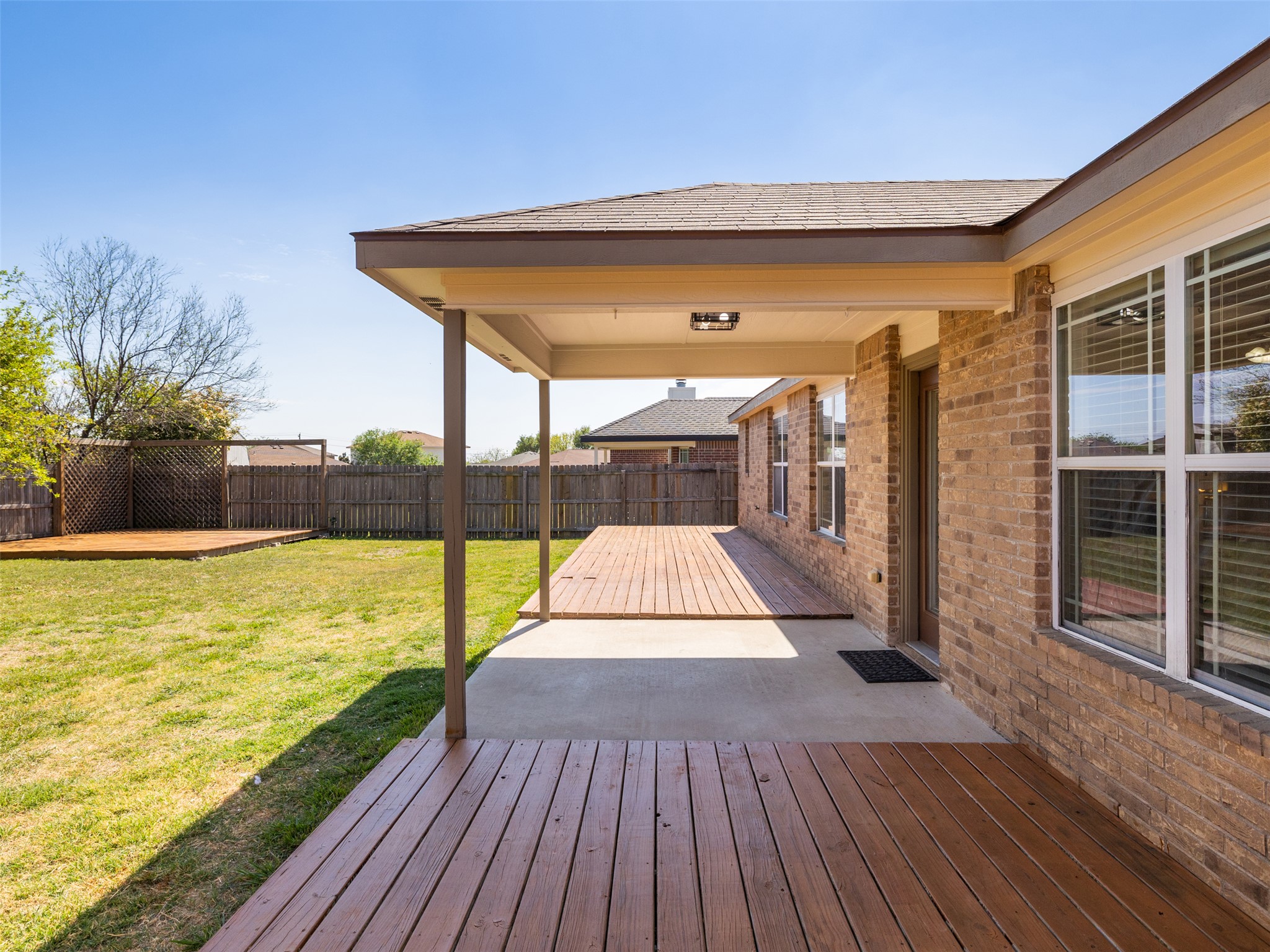 133 Lignite Drive Jarrell, TX 76537 - Photo 23 of 36 The covered patio is the perfect spot to enjoy your morning coffee or unwind in the evening, sheltered from the Texas sun year-round.