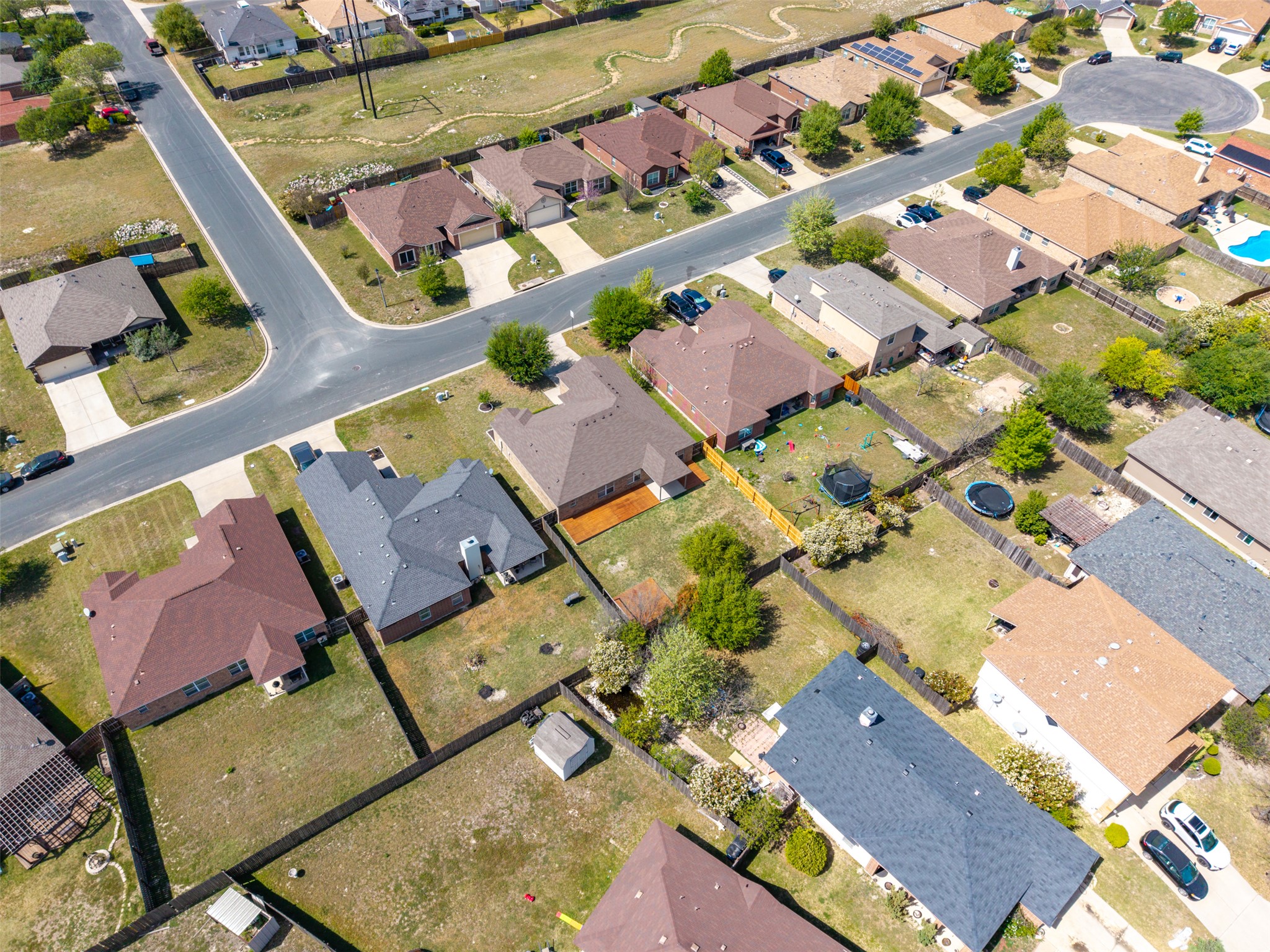 133 Lignite Drive Jarrell, TX 76537 - Photo 33 of 36 The covered patio and corner firepit area are clearly visible, giving a great sense of the outdoor entertaining layout from above.