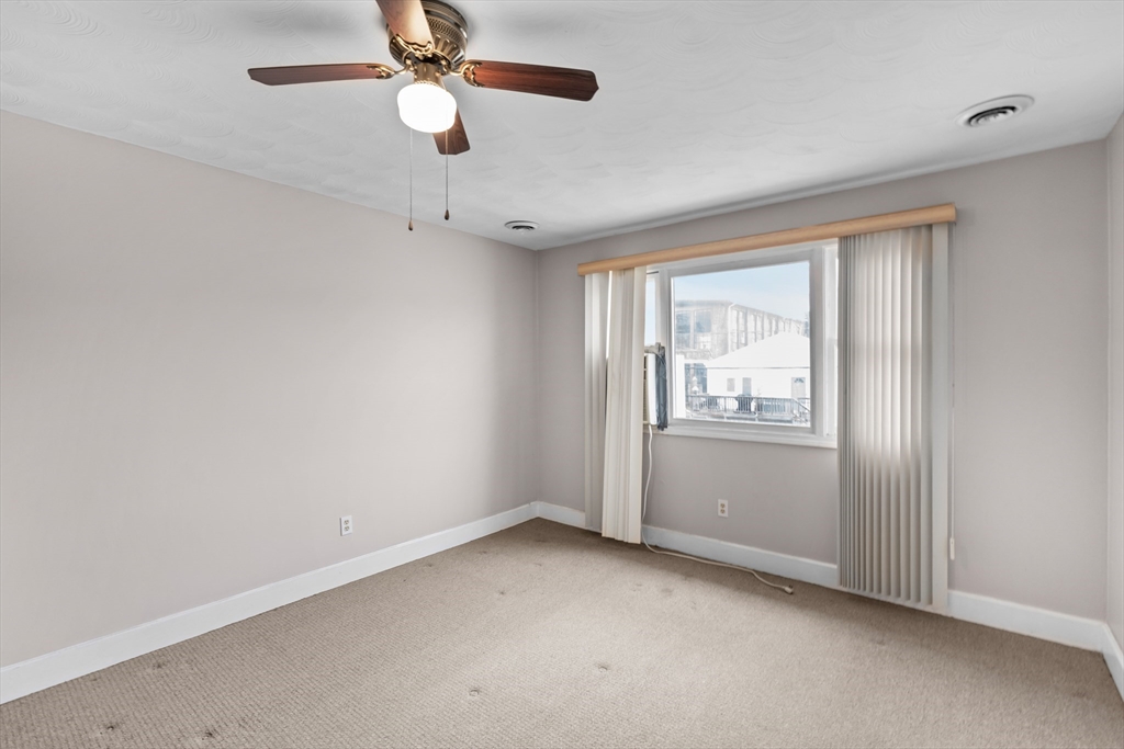 70 North Court Street, Unit F Fall River, MA 02720 - Photo 2 of 20 an empty room with windows and fan
