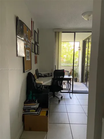 a view of a room with furniture and large windows