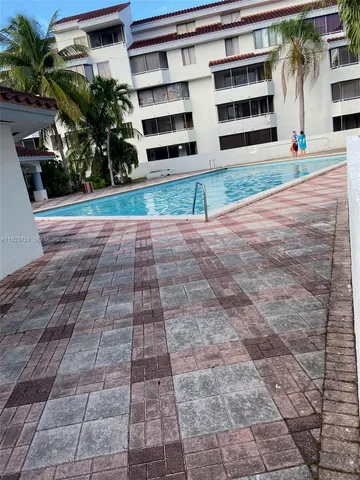 a view of swimming pool with a yard and sitting area