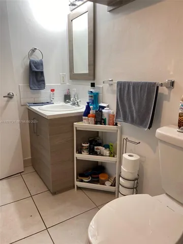 a bathroom with a toilet and a shower curtain